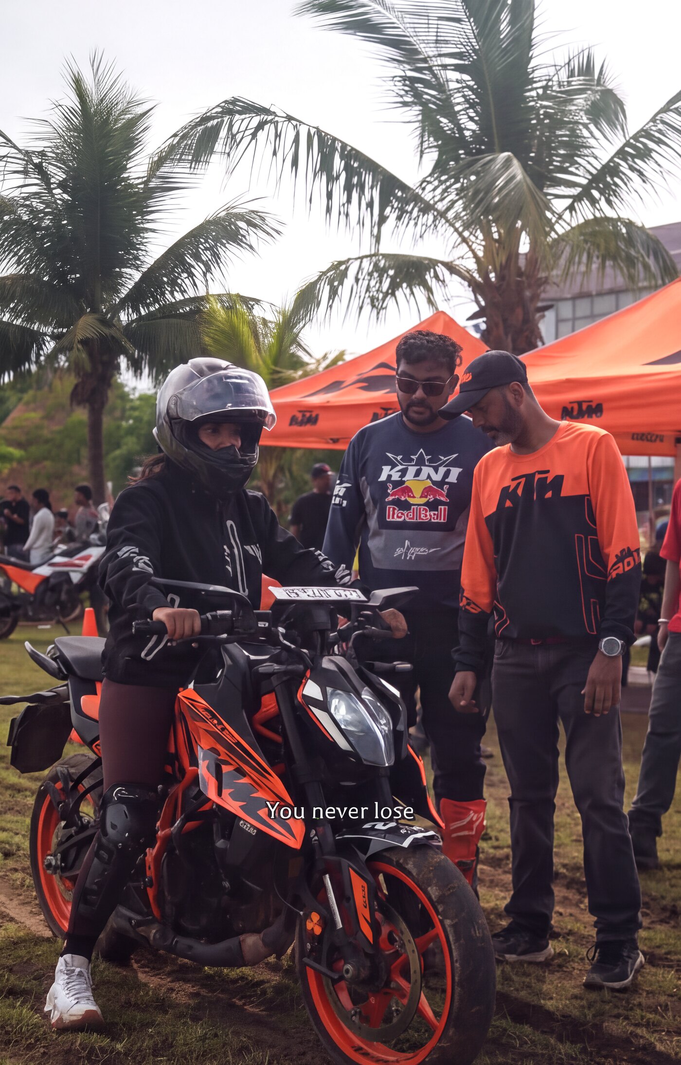 Race day at the KTM paddock — full gear, helmet on.